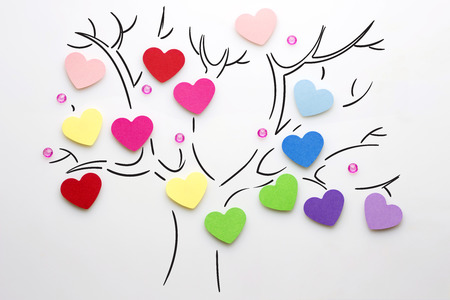 Creative valentines concept photo of hearts on the tree on white background.