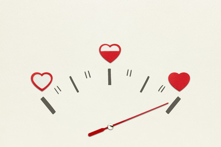 Creative valentines concept photo of speedometer with hearts on grey background.の写真素材