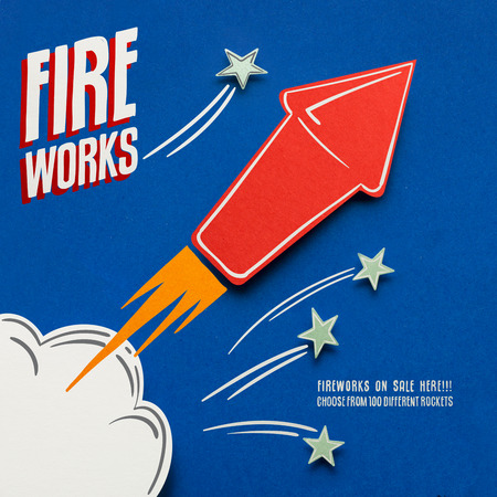 Creative 4th of July concept photo of fireworks made of paper on blue background.