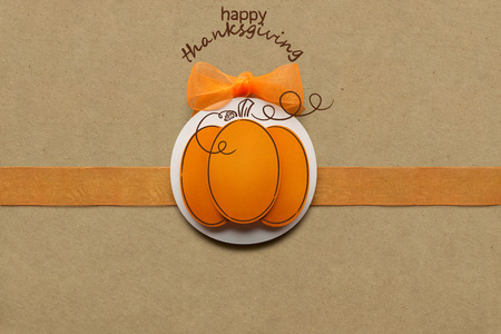 Creative thanksgiving day concept photo of pumpkin made of paper on brown background.の写真素材