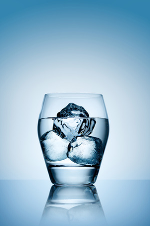 The pure freshness of transparent ice filling the glass of luxury alcohol.の写真素材