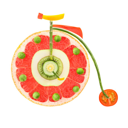 Fruits and vegetables in the shape of a vintage penny-farthing bicycle.の写真素材