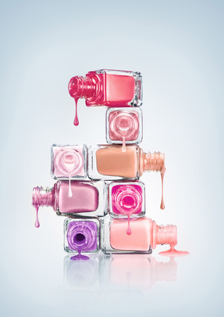 Nail polish dripping from stacked bottles.の写真素材