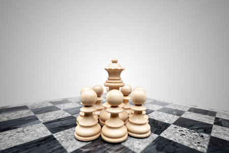 Fearless pawns standing in allround defence ready to fight for a chess queen.の写真素材