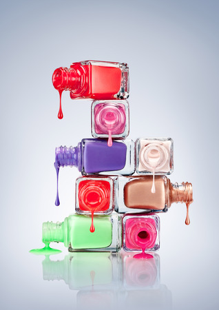 Nail polish dripping from stacked bottles.の写真素材