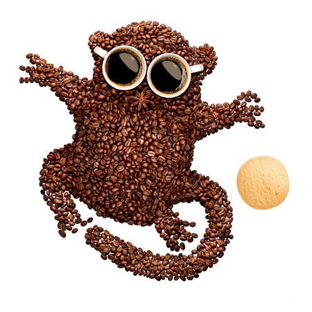 A funny tarsier made of roasted coffee beans, two cups and star anise with an oatmeal cookie, isolated on white.の写真素材