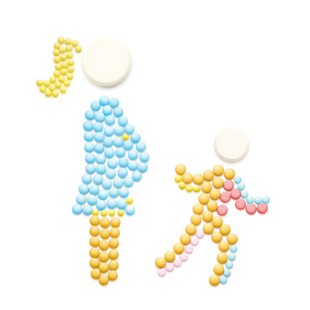 Creative medicine and healthcare concept made of pills, pregnant with IVF baby mother walking with another child, isolated on white.の写真素材