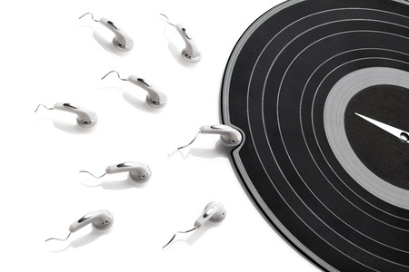 High contrasted abstraction made of gramophone record and earphones in situation of conception.の写真素材