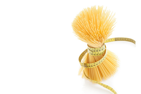 A meter coiled over the bunch of noodles forming female shape.の写真素材