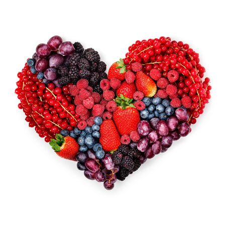 A variety of summer berries in the shape of heart as a symbol of valentine and love.の写真素材