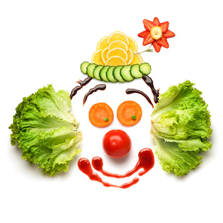 A nice and funny edible clown, made of strawberries, lemons, salad and so on.の写真素材