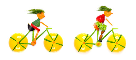 Fruits and vegetables in the shape of young cyclists riding bikes.の写真素材