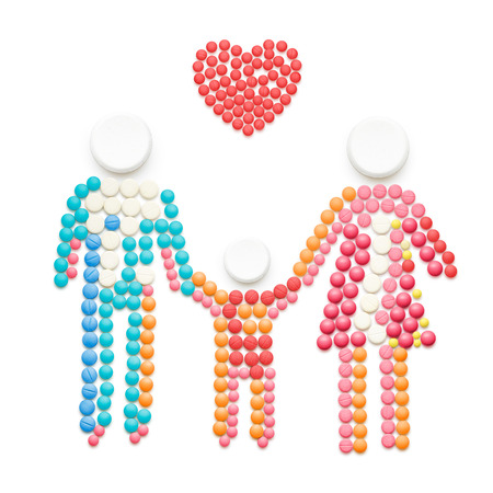 Creative healthcare concept made of drugs and pills, isolated on white. Family holding hands.の写真素材