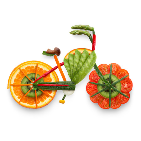 Healthy food concept of an electric bicycle in detail made of fresh vegetables and fruits full of vitamins, isolated on white.の写真素材