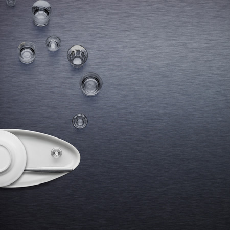 Creative dishware concept; figure of a fish blowing bubbles made of plates and glasses.の写真素材