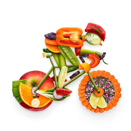 Healthy food concept of a cyclist riding a bike made of fresh vegetables and fruits, isolated on white.の写真素材