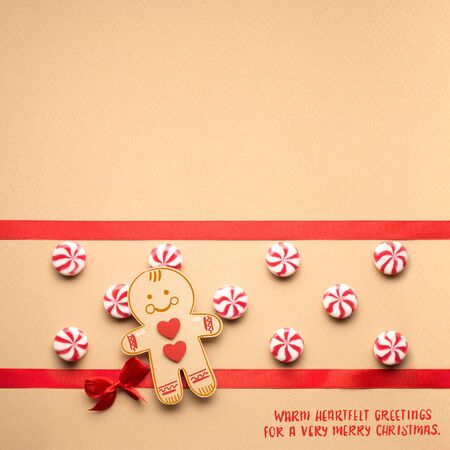 Creative concept photo of christmas candy and  gingerbread man on brown background.の写真素材