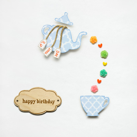 Creative concept photo of a teapot made of paper on white background.の写真素材