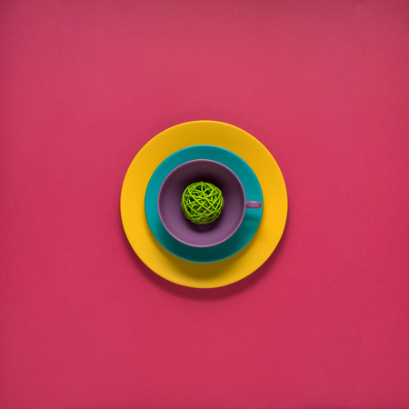 Creative concept photo of painted plates on pink background.の写真素材