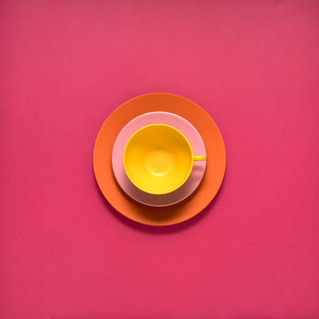 Creative concept photo of kitchenware, painted plate with food on it on pink background.の写真素材
