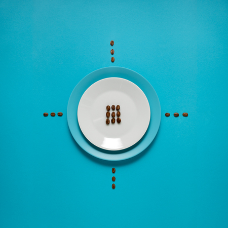 Creative concept photo of kitchenware, painted plate with food on it on blue background.の写真素材