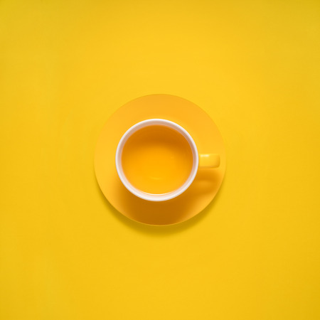 Creative concept photo of kitchenware, painted plate with food on it on yellow background.の写真素材