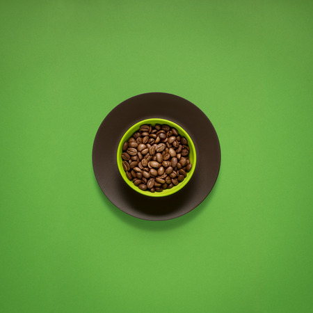 Creative concept photo of kitchenware, painted plate with food on it on green background.の写真素材