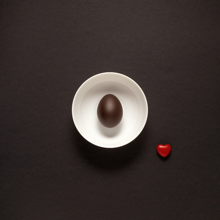 Creative concept photo of kitchenware, painted plate with food on it on black background.の写真素材