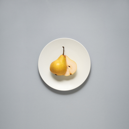 Creative concept photo of kitchenware, painted plate with food on it on grey background.の写真素材