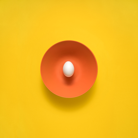 Creative concept photo of kitchenware, painted plate with food on it on yellow background.の写真素材
