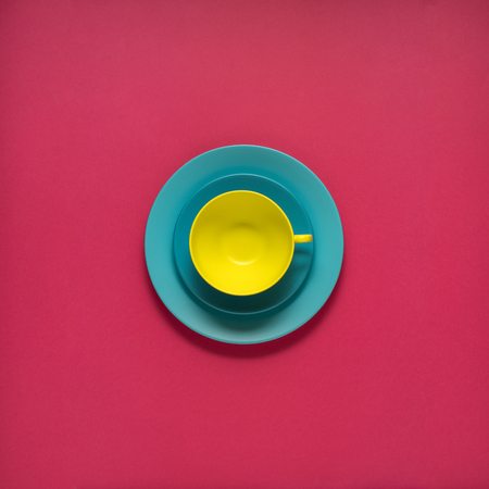 Creative concept photo of kitchenware, painted plate with food on it on pink background.の写真素材