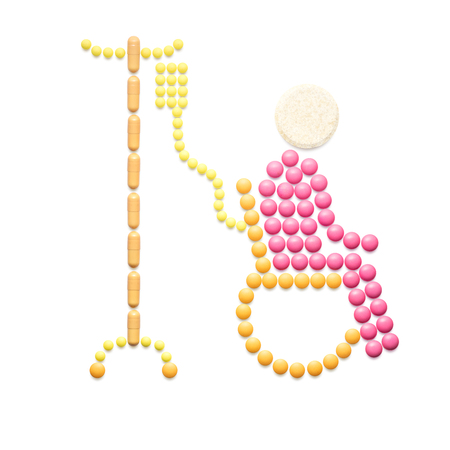 Creative medicine and healthcare concept made of pills in the shape of a patient with wheelchair on white background.の写真素材