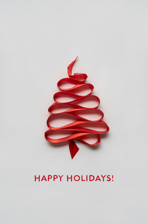 Creative concept photo of christmas tree made of ribbon on white background.の写真素材