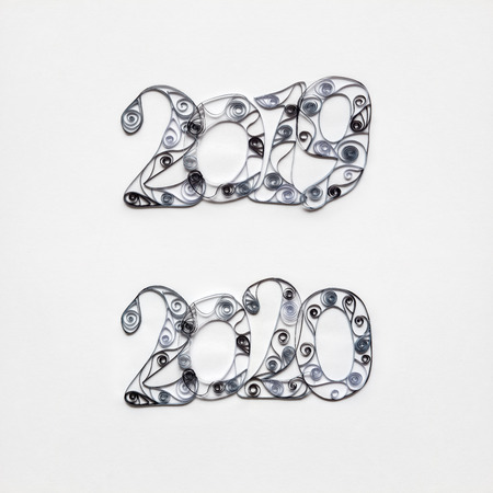 Creative concept photo set of 2019 and 2020 sign made of paper on white background.の写真素材