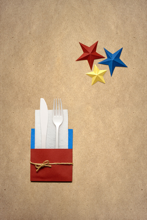 Creative 4th of July concept photo of kitchenware made of paper on brown background.の写真素材