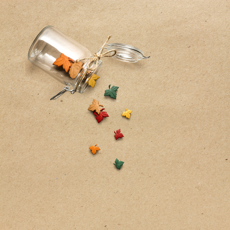 Creative thanksgiving day concept photo of leaves falling from the bottle on brown background.の写真素材