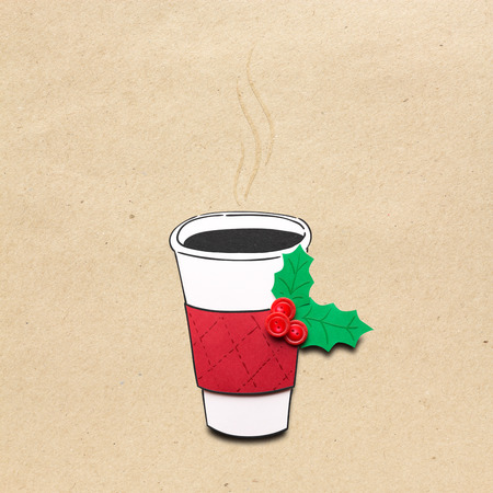 Creative concept photo of christmas take away coffee cup made of paper on brown background.の写真素材