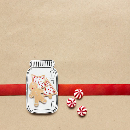 Creative concept photo of christmas candy and  gingerbread man on brown background.の写真素材
