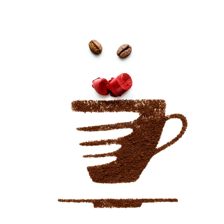 Creative concept photo of cup and lipstick made of coffee on white background.の写真素材