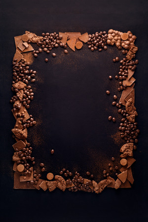 Creative concept photo of frame made of chocolate on black background.の写真素材