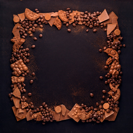 Creative concept photo of frame made of chocolate on black background.の写真素材