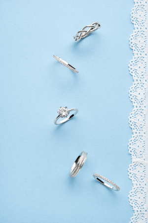 Creative concept photo of jewelry rings on blue background.の写真素材