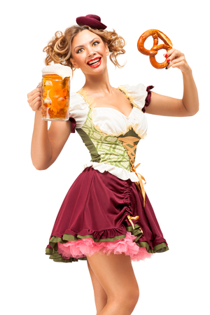 Creative concept photo of Oktoberfest waitress wearing a traditional Bavarian costume with beer and pretzel isolated on white background.の写真素材