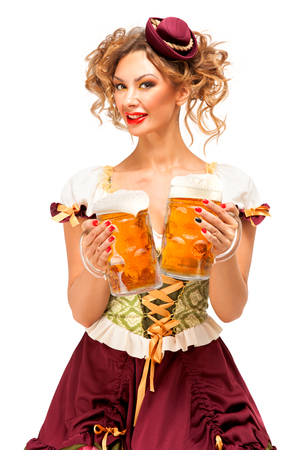 Creative concept photo of Oktoberfest waitress wearing a traditional Bavarian costume with beer isolated on white background.の写真素材