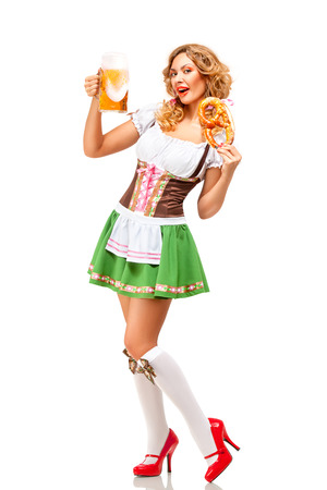 Creative concept photo of Oktoberfest waitress wearing a traditional Bavarian costume with beer and pretzel isolated on white background.の写真素材