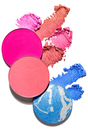 Creative concept photo of cosmetics swatches beauty products lipstick round eyeshadow on white background.の写真素材