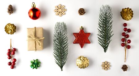 Creative concept still life holiday photo of pine tree branches berries with Christmas toys decorations and present gift boxes on white background.の写真素材