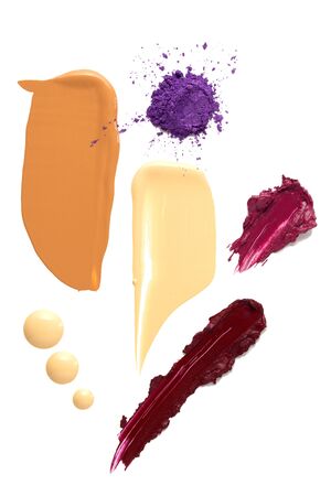 Creative concept photo of cosmetics swatches beauty products foundation cream with lipstick and eyeshadow on white background.の写真素材