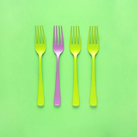 Creative concept still life food diet health photo of painted forks tableware utensil cutlery on green background.の写真素材