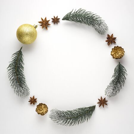 Creative concept still life holiday Christmas photo of pine tree branches and berries in the shape of wreath on white background.の写真素材
